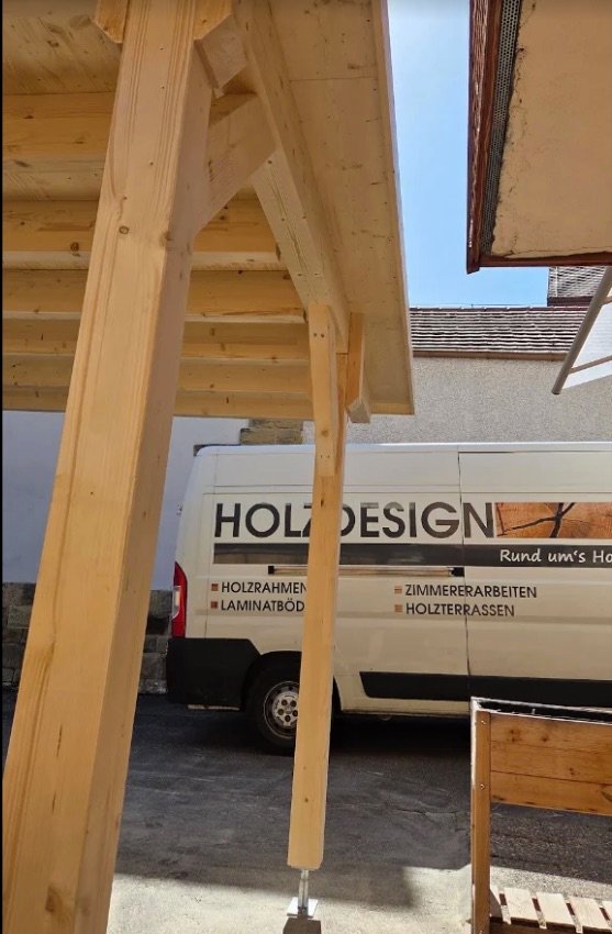 Neu errichtete Holzkonstruktion aus Vollholz-Ständern, im Hintergrund der Firmentransporter von Holzdesign.